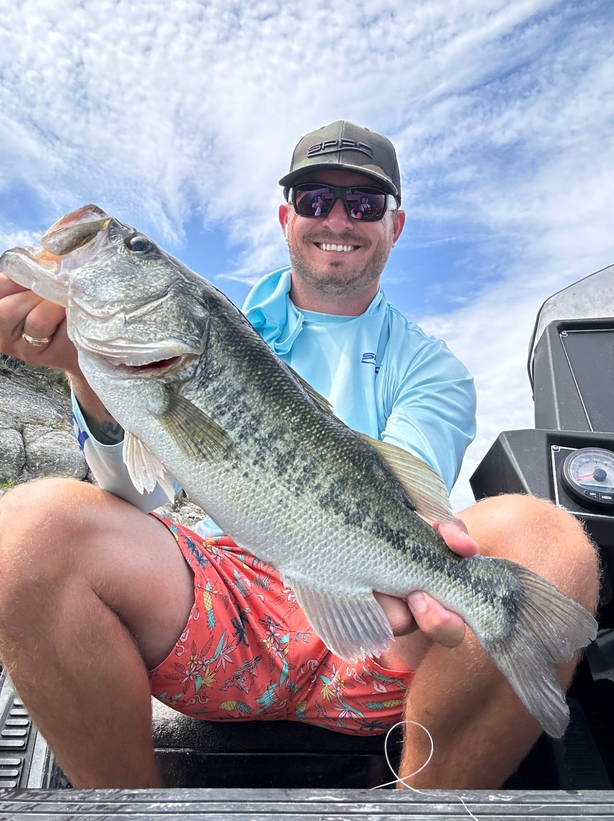 An angler cradling a heavy largemouth bass on Stillhouse Hollow